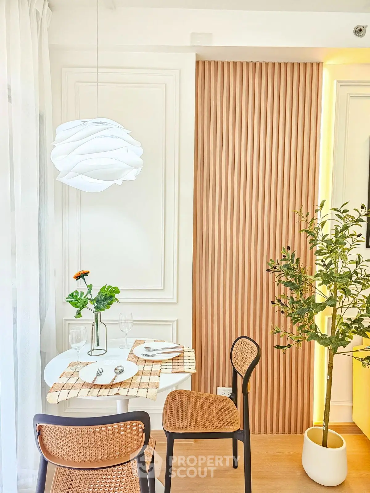 Stylish dining area with modern decor and elegant lighting in a cozy apartment setting.