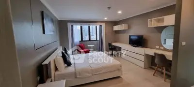 Modern bedroom with sleek furniture and city view, perfect for urban living.