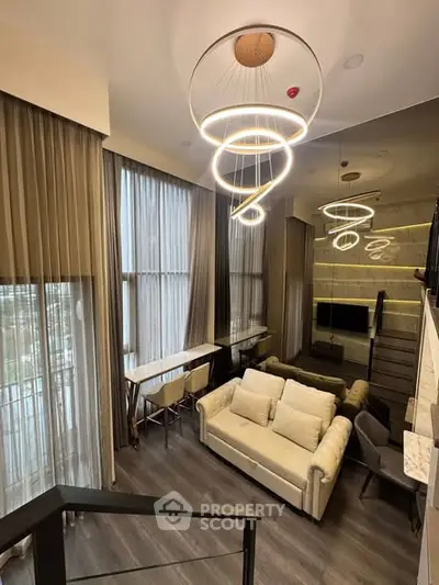 Luxurious modern living room with high ceilings and elegant lighting fixtures