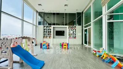 Spacious children's playroom with city view, featuring colorful toys and modern design.