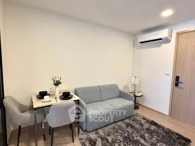 Modern living room with cozy sofa, dining set, and air conditioning in a stylish apartment.