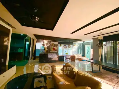 Luxurious open-plan living room with modern decor and ample natural light.