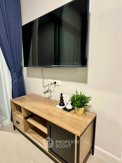 Modern living room with sleek TV setup and stylish wooden console