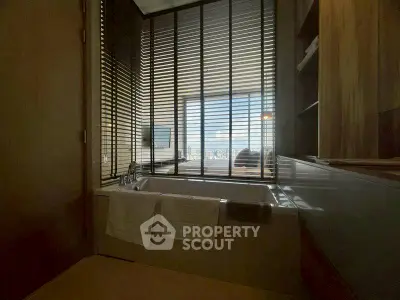 Luxurious bathroom with city view and modern design in high-rise apartment.