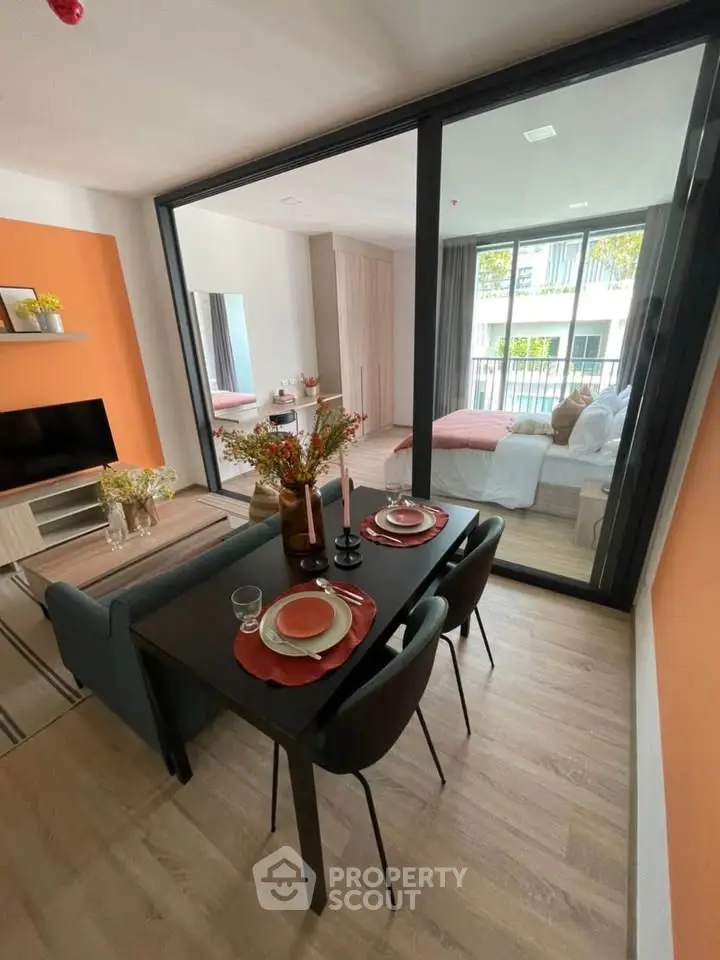 Modern open-layout living and dining area with stylish decor and large windows.