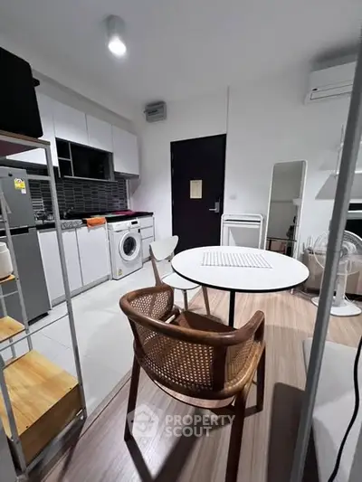 Modern compact kitchen with washing machine and stylish dining area