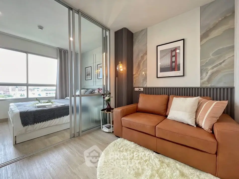 Modern living room with glass partition and cozy bedroom view