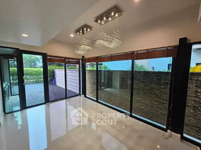 Spacious modern living room with large windows and elegant lighting