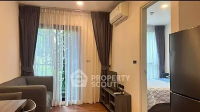 Cozy living room with modern decor and natural light, featuring a sleek air conditioner and stylish furniture.