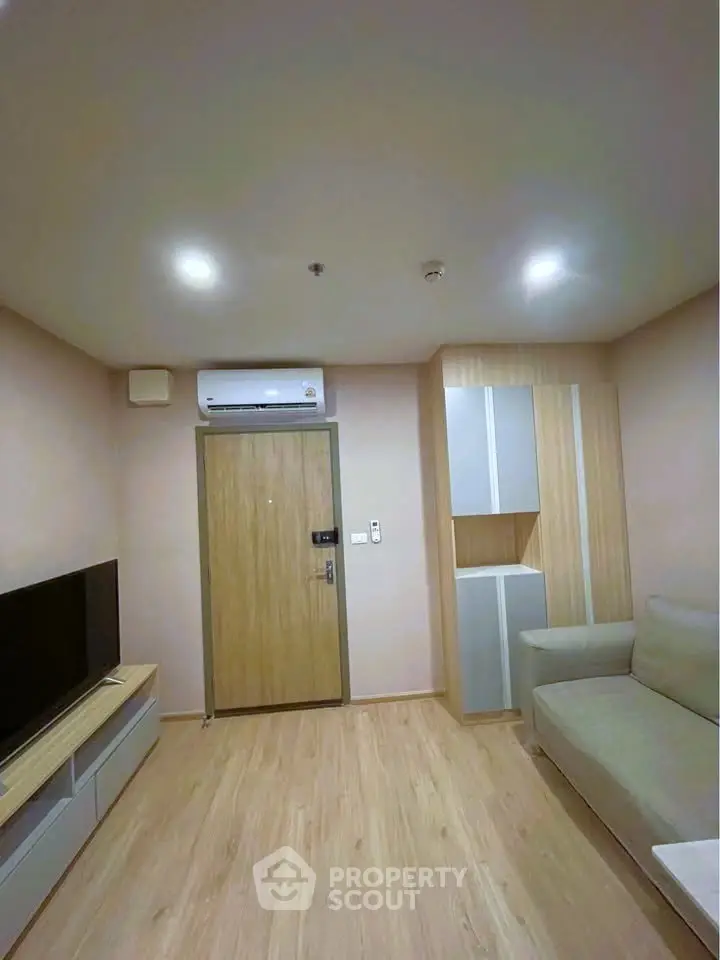 Modern living room with sleek design, featuring a comfortable sofa and wall-mounted TV for ultimate relaxation.