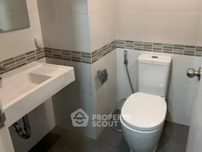 Modern bathroom with sleek fixtures and neutral tile design.