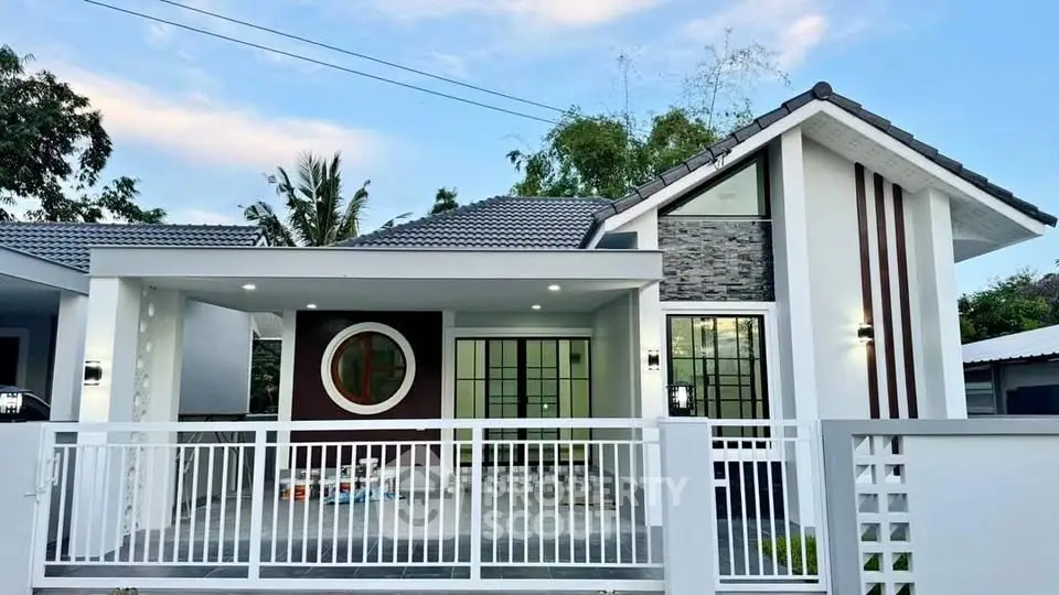 Modern single-story house with stylish facade and spacious front yard.
