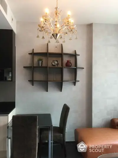 Elegant living room with chandelier and modern wall shelf