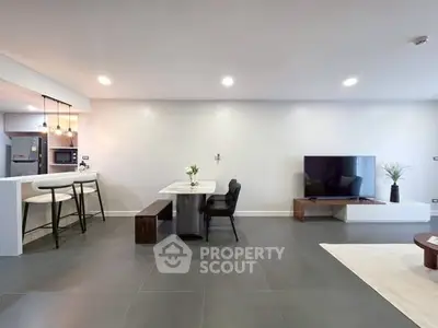 Spacious modern living room with open kitchen and sleek decor