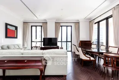 Luxurious living room with elegant furniture and large windows offering city views.
