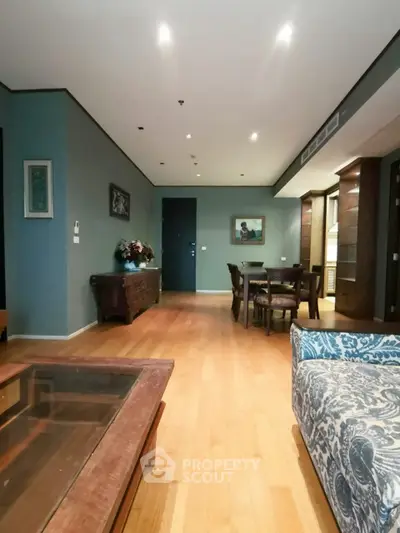 Spacious living room with elegant wooden flooring and stylish furniture