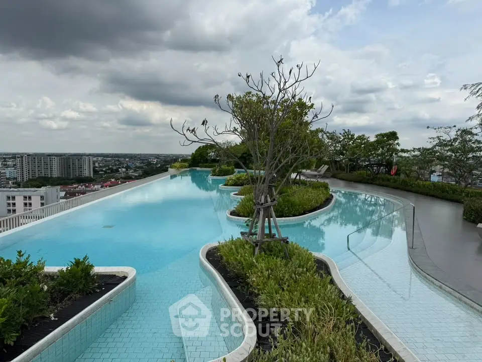 Stunning rooftop infinity pool with panoramic city views and lush greenery.