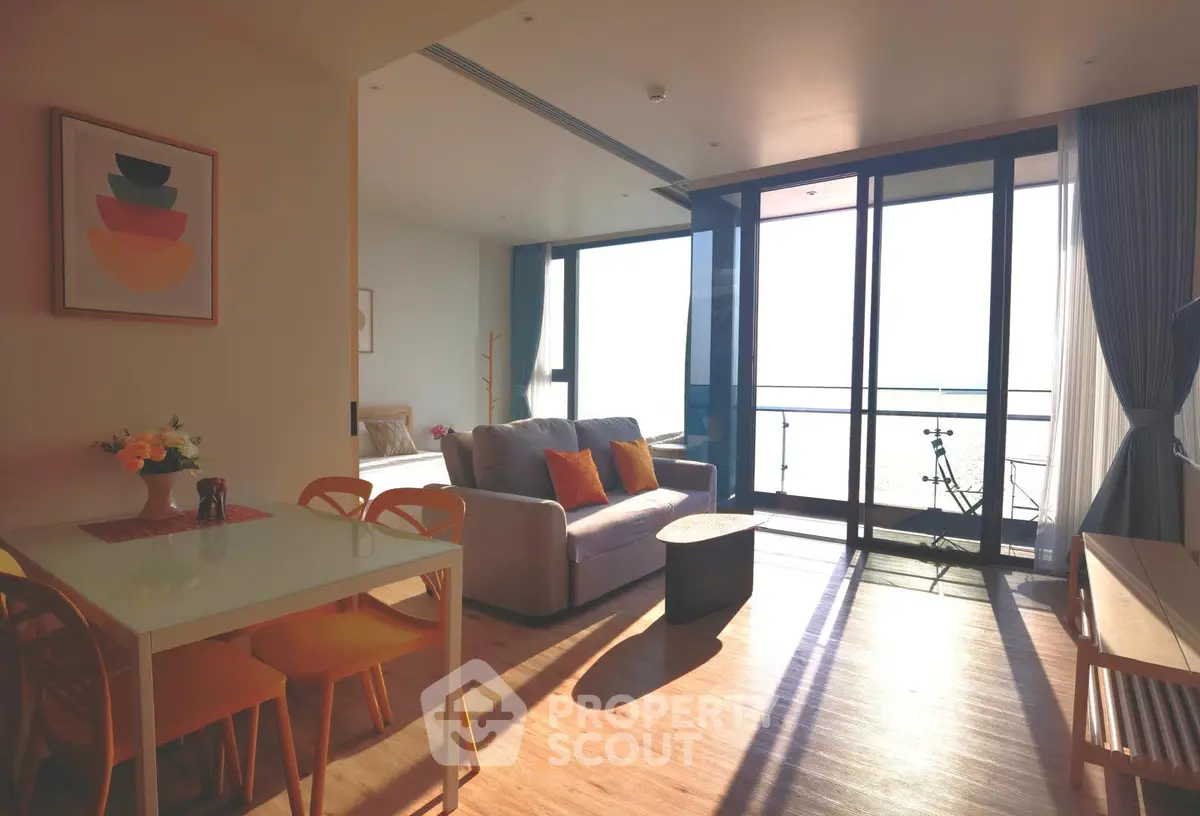 Modern living room with ocean view, featuring cozy seating and dining area, perfect for relaxation and entertaining.