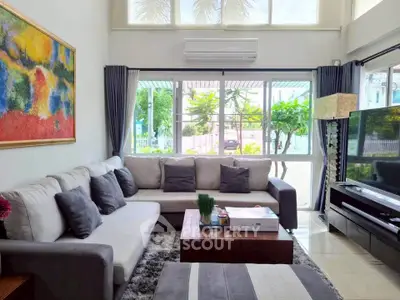 Spacious living room with modern decor and large windows for natural light.