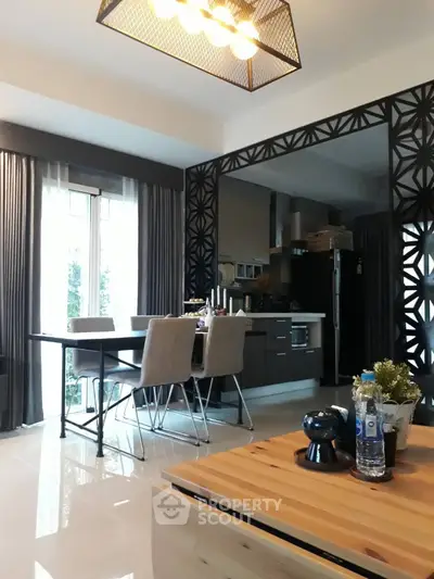 Modern open-layout kitchen with dining area and stylish decor