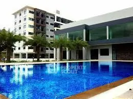 Luxurious apartment complex with stunning pool and modern architecture.