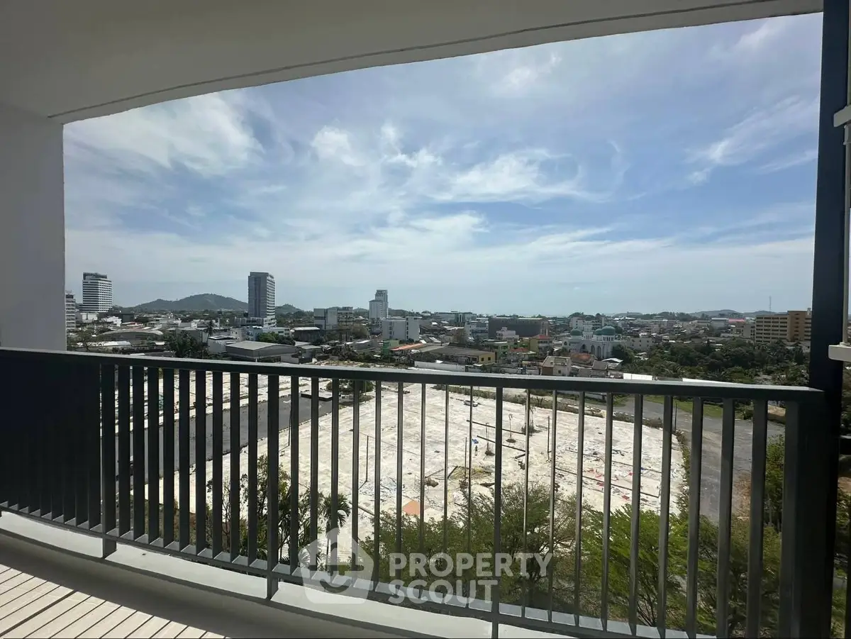 Stunning cityscape view from a spacious balcony in a modern apartment.