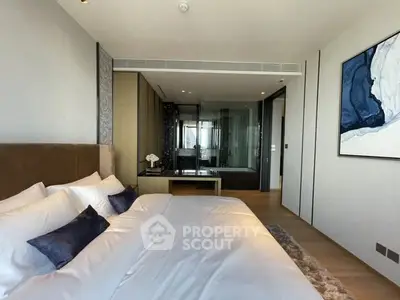 Luxurious bedroom with modern decor and ensuite bathroom in upscale apartment