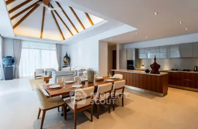 Luxurious open-plan living and dining area with modern kitchen and vaulted ceiling
