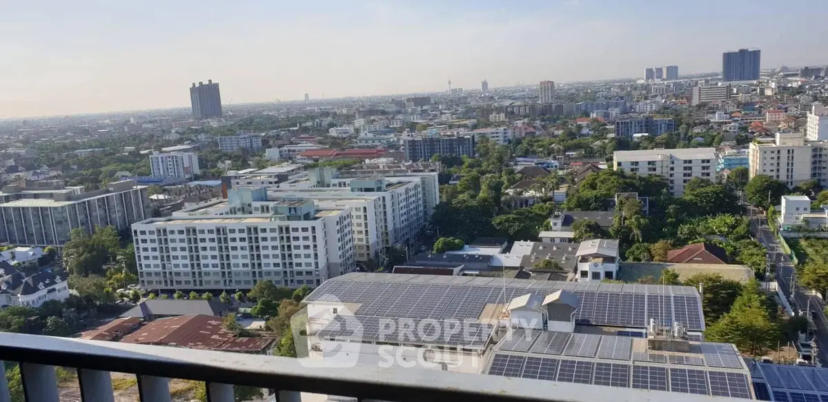 Stunning cityscape view from a high-rise balcony showcasing urban living and solar-powered buildings.