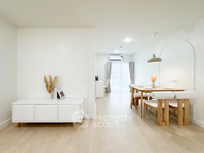 Spacious modern living and dining area with minimalist decor and natural light.