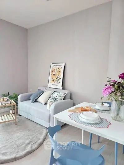 Charming living room with cozy sofa, stylish decor, and elegant dining setup, perfect for modern living.