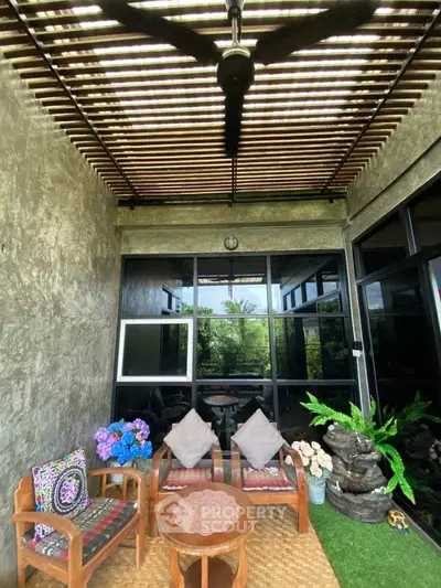 Charming balcony with cozy seating and lush greenery, perfect for relaxation and outdoor enjoyment.