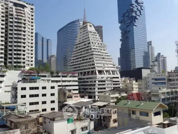 Stunning cityscape featuring unique pyramid-shaped building amidst modern skyscrapers.