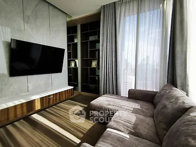 Modern living room with large TV, stylish sofa, and floor-to-ceiling windows offering city views.