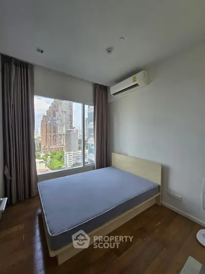Modern bedroom with city view and air conditioning in high-rise apartment