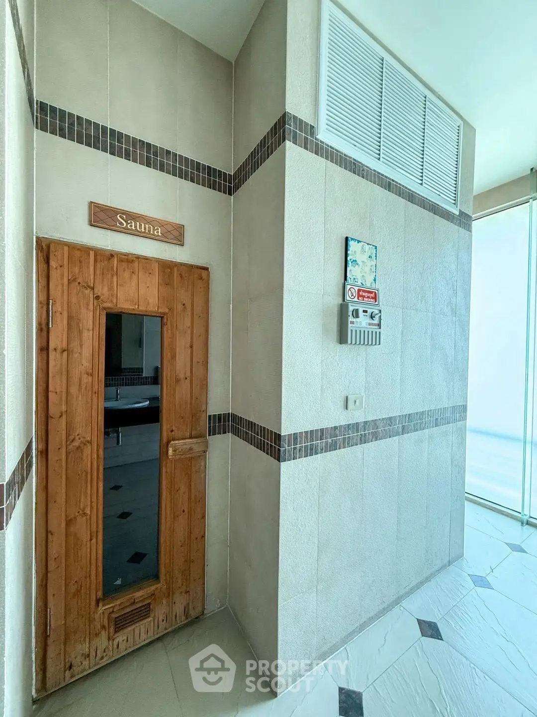 Luxurious sauna entrance in modern residential building with elegant tile design.