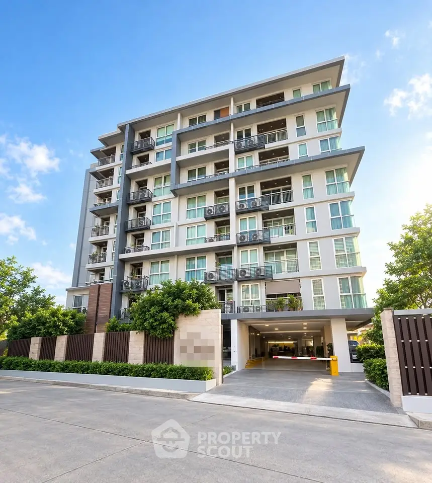 Modern multi-story apartment building with balconies and lush greenery, ideal for urban living.