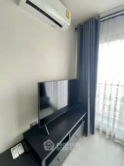 Modern living room with sleek TV setup and air conditioning