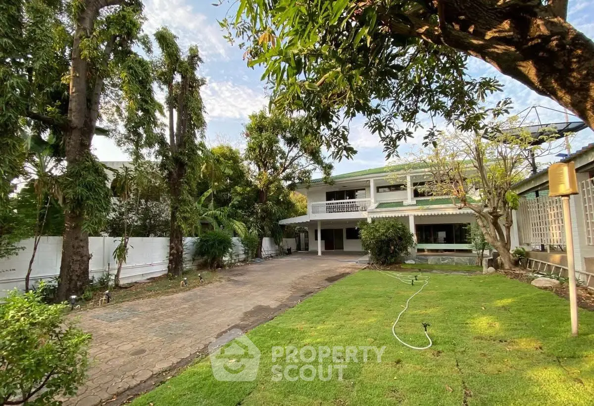 Charming two-story house with lush garden and spacious driveway