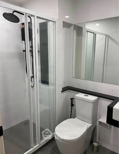 Modern bathroom with sleek shower and contemporary fixtures in a stylish apartment.
