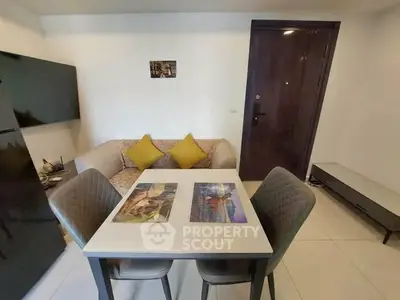 Cozy living room with modern decor and dining area in a stylish apartment.