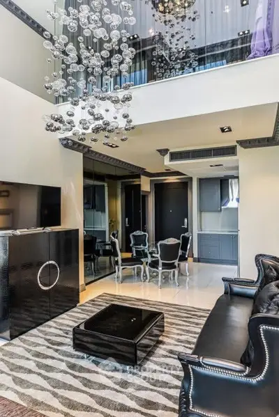Luxurious modern living room with high ceiling and elegant chandelier