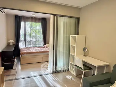 Modern studio apartment with sliding glass partition and stylish furnishings
