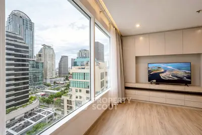 Modern living room with stunning city view and sleek wooden flooring.