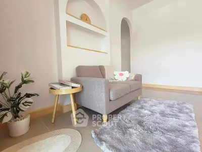 Cozy living room with modern sofa and plush rug, perfect for relaxation.