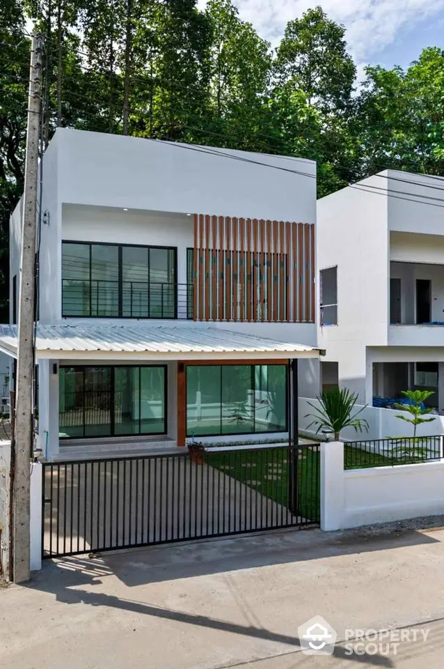 Modern two-story house with sleek design and gated entrance