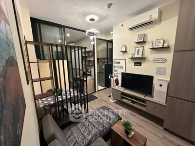 Modern living room with stylish decor and open layout, featuring a cozy seating area and wall-mounted TV.