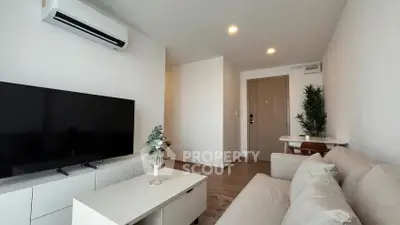 Modern living room with sleek furniture and air conditioning, perfect for relaxation.