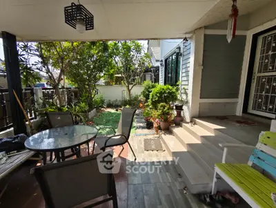 Charming garden patio with outdoor seating and lush greenery
