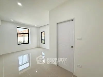 Spacious and bright empty room with large windows and glossy tiled floor, perfect for customization.